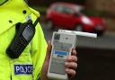 File photo of of a Road Traffic constable holding a breathalyser. Picture: PA Images