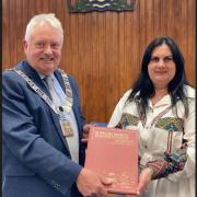 Ribble Valley Mayor Mark Hindle is pictured with Olha Vazhova, head teacher at School 4 in Vinnystia, Ukraine, presented him with a book printed in Ukrainian and English showing the country's many regional heritage sites.