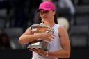 Iga Swiatek poses with the trophy after defeating Aryna Sabalenka in the final of the Italian Open (Alessandra Tarantino/AP/PA)