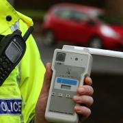 File photo of of a Road Traffic constable holding a breathalyser. Picture: PA Images