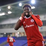 Offrande Zanzala celebrates after scoring a penalty in the win over Oldham Athletic
