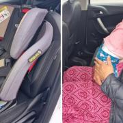 A driver was summoned to court due to a passenger carrying a child in her lap.