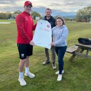 Club professional, Garnett Tarr, presents a Salesbury CC shirt to Jasmine Bell and Adam Pearson from My Adventure Campers