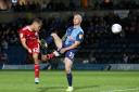 Dion Charles heads home for Accrington Stanley in the 1-1 draw at Wycombe Wanderers last night Pictures: KIPAX