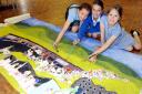 ENTHUSIASTIC: Leah Spalding, eight, Tess Gazzard, ten, and Joy Maddock, nine, with the school’s mural