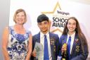Headboy and girl Kasom Shah and Katie Lister collect last year's Head Teacher of the Year Award on behalf of Richard Varey of Blessed Trinity RC College, Burnley, from Jane Scott