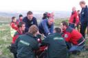 TREATMENT: Paramedics and Bolton Mountain rescuers attend to the injured cyclist