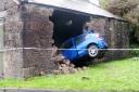 DEMOLISHED: The MG-ZR embedded in the barn after the driver crashed through the outer wall