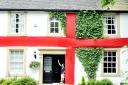 Alex Bendell, 10, outside his house in Pleasington which has been transformed into a giant England flag