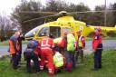 Members of Bolton Mountain Rescue Team, Bowland Pennine Mountain Rescue Team and paramedics from the North West Air Ambulance, preparing to put the injured man into the helicopter