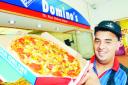 APPEAL: Area manager Shoaib Ravat serves up a halal pizza at Domino’s Pizza,