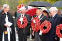 Ribble Valley Mayor Michael Ranson and wreath layers, and a youngster in Earby