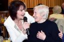 Singer Joyce Kay of Blackburn, is joined on the mike by 89 year old Kathleen Heys of Darwen, during the Good Friends afternoon at Derwent Hall, Darwen.