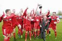 DELIGHT: Darwen’s players lift the play-off trophy having secured promotion to the North West Counties League Premier Division