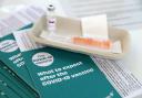 Covid-19 vaccine leaflets sit beside a vaccine vial as the Scottish Government announces it has vaccinated over two million people, as lockdown measures for mainland Scotland continue. Picture date: Wednesday March 17, 2021. PA Photo. See PA story