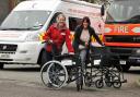 The Red Cross receive wheelchairs donated by the Gannett Foundation to Alison Foy and Sarah Collins