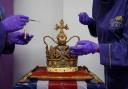 Cadbury World chocolatiers Dawn Jenks and Donna Oluban add the finishing touches to a 45cm tall chocolate replica of St Edward's Crown at Cadbury World in Birmingham.