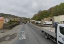 A lane of Bacup Road in Waterfoot, off Holt Mill Road, is closed as emergency services deal with a crash