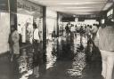 Shoppers paddling through the floodwater at Blackburn shopping precinct in 1987