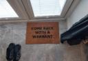 A welcome mat inside one of the raided properties