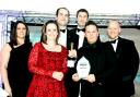 Gareth Frankland (second from right), CEO of acdc LED, collects the award