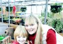 Melissa Peters works with her six-year-old son Fergus, potting plants at the centre