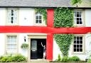 Alex Bendell, 10, outside his house in Pleasington which has been transformed into a giant England flag
