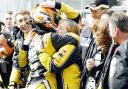 DELIGHT: Adam Morgan gets a hug from his team after finishing third in race two at Donington Park