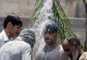 People cool themselves off with water in Peshawar, Pakistan. Over 1000 people lost their lives due to a weeklong heat wave in the Karachi