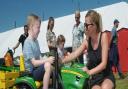 Alfie Reynolds with mum, Katie Curson with a mini tractor
