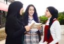 GCSE results day at Blackburn Central high School. From left, Amirah Bhamji, Kiran Khan and Mariam Sidat discuss where they are going next.
