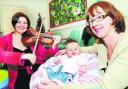 MINI MOZART FAN: Six-month-old Jessica Cullivan and her mum Jackie, of Worsthorne, get a rendition from Rachel Jones on her viola
