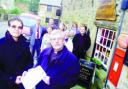 PETITION: Graham Wilkinson and the Venerable John Hawley with local residents outside Chipping's threatened post office