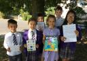 Pupils from Thorneyholme Primary School holding their letters to famous authors
