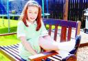 BACK HOME: Hollie relaxes in the garden after school
