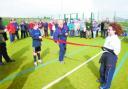 A CUT ABOVE: Hockey legend Val Robinson cuts the ribbon to official open the new hockey pitch