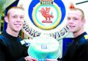 KITTED OUT: Adam and Nick Crabtree with a cake made as a special treat by chef instructors