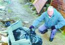 aWHAT A MESS: Martin Baybutt surveys the fly-tipping at the rear of his Gents hairdressers at Intack traffic lights