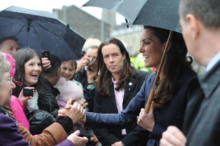 Kate Middleton greets the crowds as she and Prince William arrive at Darwen.