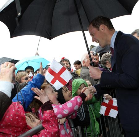 Prince William shakes hands with young fans at Darwen Aldridge Academy.