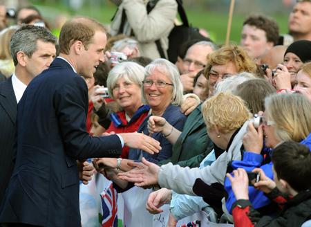 Prince William shakes hands with members of the public as the rain briefly stopped at Witton Park.