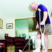 STILL PUTTING: Jim Sawn keeps up the golf while on crutches recovering at home from his broken ankle			  Picture HELEN BROWN