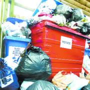 PILED HIGH: The overflowing rubbish containers at the block of flats
