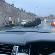 A car has flipped onto its roof while driving along the A56 Colne Road in Kellbrook. PIC CREDIT: Tracy Glegg