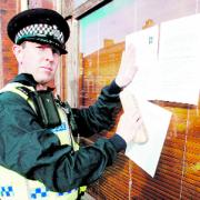 CLOSURE: An officer leaves the notice at the Leamington Road house