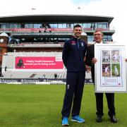 England's James Anderson is presented with a framed photo by Lancashire CCC Chairman David Hodgkiss OBE as the old Pavilion End is renamed the James Anderson End during the Fourth Investec Test at Emirates Old Trafford, Manchester.