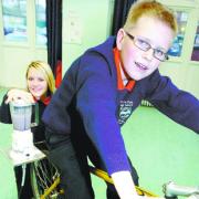 Alexandra Gallagher, 13, and Christian Talbot, 12, keep the operation running on the static bike