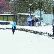 BLACKBURN: Two boys play football on the frozen canal in Ewood with passers-by in the background