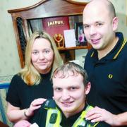 COP THAT:  PC David Fisher holds baby Jessica watched by mum and dad Amanda and Andrew Sanders