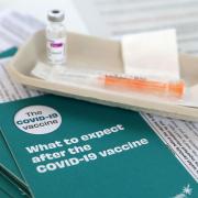 Covid-19 vaccine leaflets sit beside a vaccine vial as the Scottish Government announces it has vaccinated over two million people, as lockdown measures for mainland Scotland continue. Picture date: Wednesday March 17, 2021. PA Photo. See PA story